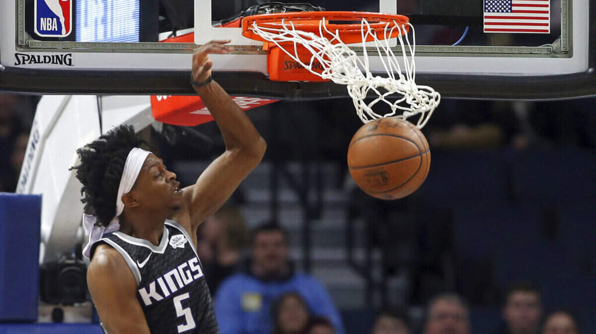 De’Aaron Fox of the Sacramento Kings scores on a dunk against the Minnesota Timberwolves in the first half Monday night, Feb. 25, in Minneapolis. Fox scored 23 points, but the Kings lost 112-105 and failed to gain ground in the Western Conference playoff race.