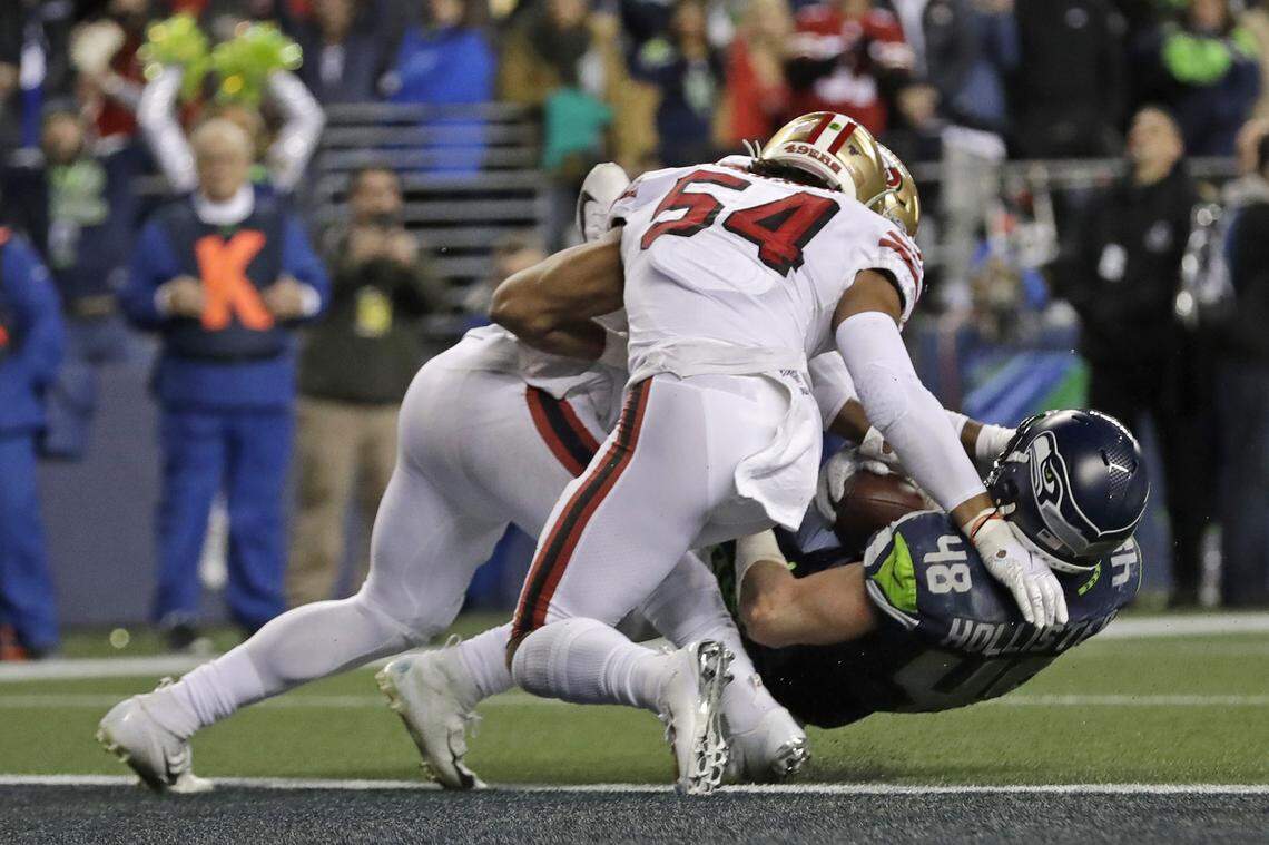 Seattle tight end Jacob Hollister is stopped just short of the goal line by San Francisco linebacker Dre Greenlaw, left, on the Seahawks’ final offensive play of the game Sunday night.