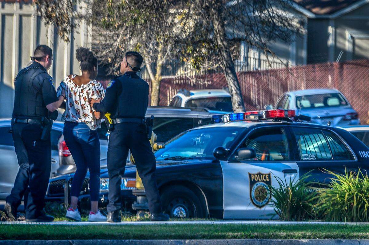 A 12-year-old girl is escorted to a Sacramento Police car at the Children’s Receiving Home on in February. She said she’d been sleeping on a couch at the Centralized Placement Support Unit for 3 days after leaving her foster home. She often leaves the facility and goes AWOL, she said, “just to see if anyone will notice and follow me.”