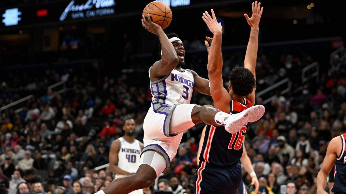 Sacramento Kings guard Terence Davis (3) shoots over Washington Wizards forward Anthony Gill (16) during the first half at Capital One Arena on Saturday in Washington, D.C.
