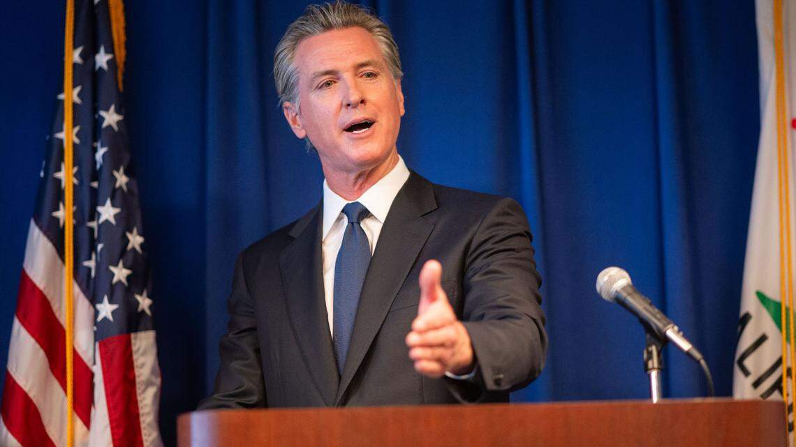 Gov. Gavin Newsom answers questions from the media Wednesday at a California Department of Justice press conference in Sacramento.