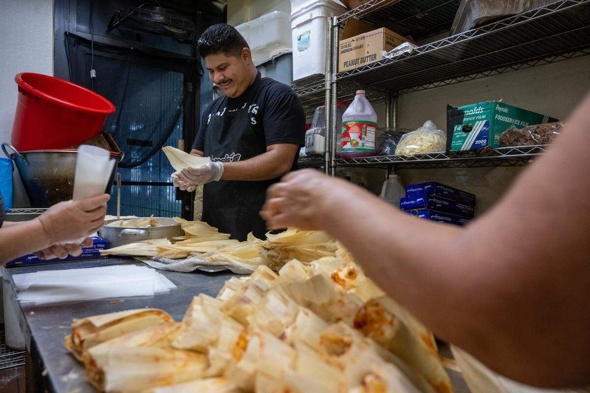 Owner Andres Yanez helps makes tamales at Yolanda’s Tamales Factory in Sacramento in 2022. 