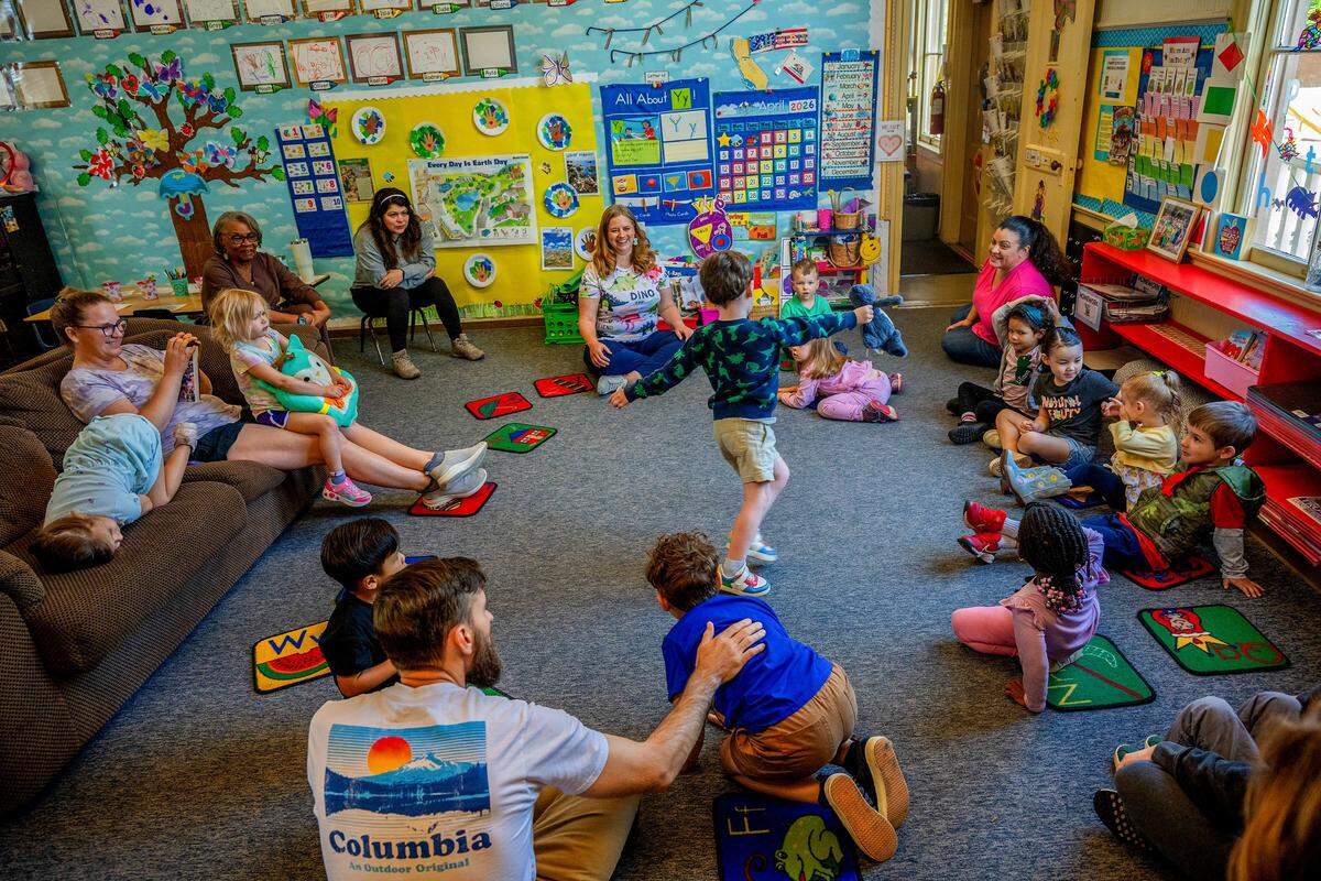 Teacher Amanda Chapman, center back, looks on as a preschooler shows off his stuffed animal during show-and-tell at Edward Kelley parent participation preschool in Rosemont on Thursday. Chapman takes pride in the educational decorations she has added to the historic schoolhouse, where she has taught for the past 10 years.