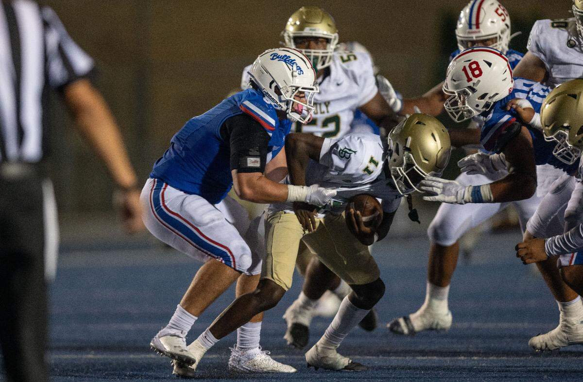 The Folsom Bulldogs’ Theo Greule (9) sacks Long Beach Poly quarterback William Jefferson (11) on Friday, Aug. 23, 2024.
