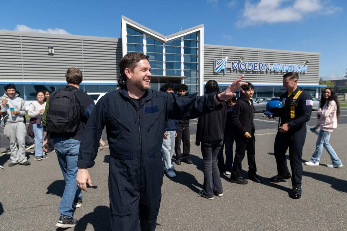 Mills Middle School teacher Jason McKnight waves to his students before his 45-minute flight with the Blue Angels at Mather Airport on Tuesday, March 18, 2025, in Rancho Cordova. The California Capital Airshow returns to Mather Airport on March 22 and 23.