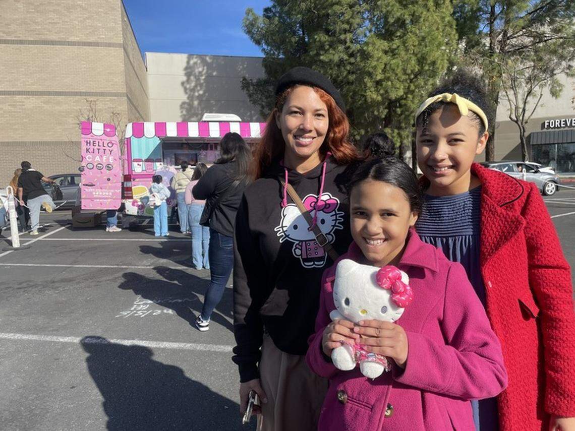 Elly Ellis, left, with her two daughters Harley, middle, and Aubrie, wait in line for the Hello Kitty Cafe pop-up in Sacramento on Saturday, Jan. 4, 2025.