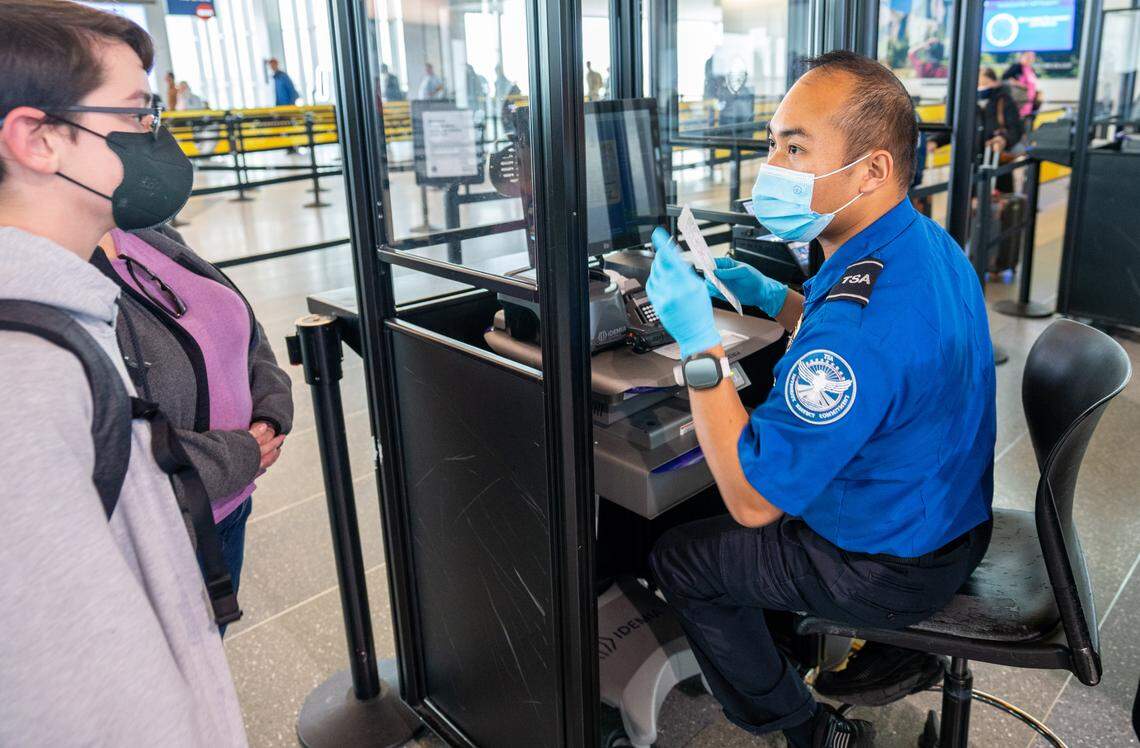 A Sacramento International Airport Terminal B TSA officer scans a passenger’s ticket as they enter into the security checkpoint on December 20, 2022.
