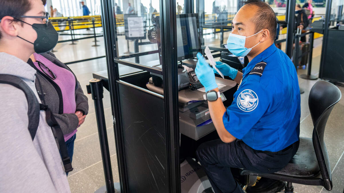 A Sacramento International Airport Terminal B TSA officer scans a passenger’s ticket as they enter into the security checkpoint on December 20, 2022.