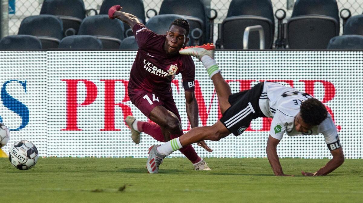 Sacramento Republic FC defender Ashkanov Apollon goes after the ball with Tacoma Defiance midfielder Antonee Burke-Gilroy (98) in a game without spectators at Papa Murphyís Park on Monday, July 13, 2020. It was the first professional sporting event on California soil after a four-month hiatus because of the coronavirus pandemic.