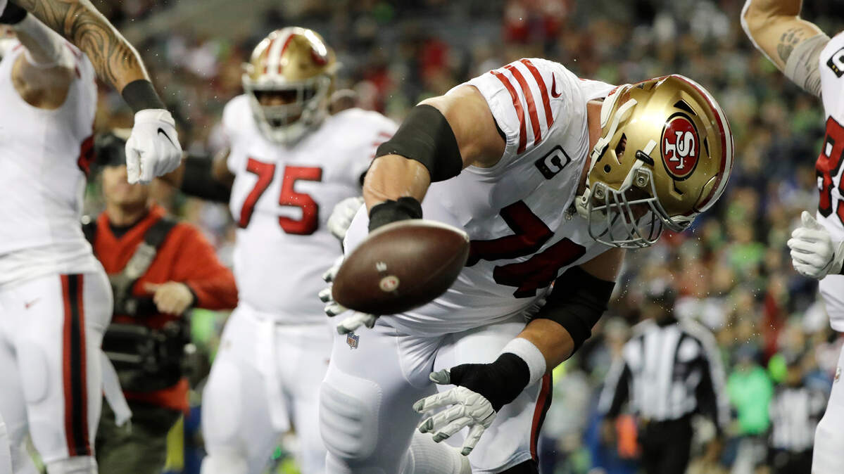 San Francisco’s Joe Staley spikes the football after a touchdown run by Raheem Mostert on Sunday.