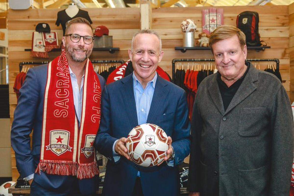 Sacramento Mayor Darrell Steinberg (center) poses with Major League Soccer investors Matt Alvarez (left) and Ron Burkle (right) on Sept. 16, 2019.