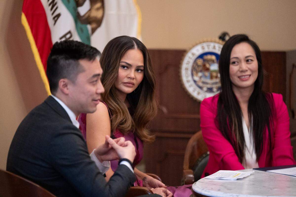Former supermodel Chrissy Teigen, center, who is advocating for a food insecurity bill by Alex Lee, left, who represents San Jose in the Assembly, and Assemblymember Stephanie Nguyen, D-Elk Grove, at the state Capitol on Monday.