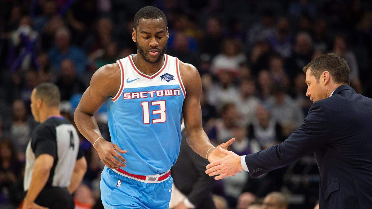 Sacramento Kings guard Alec Burks (13) slaps hands with head coach Dave Joerger at Golden 1 Center on Sunday, Feb. 10, 2019 in Sacramento.