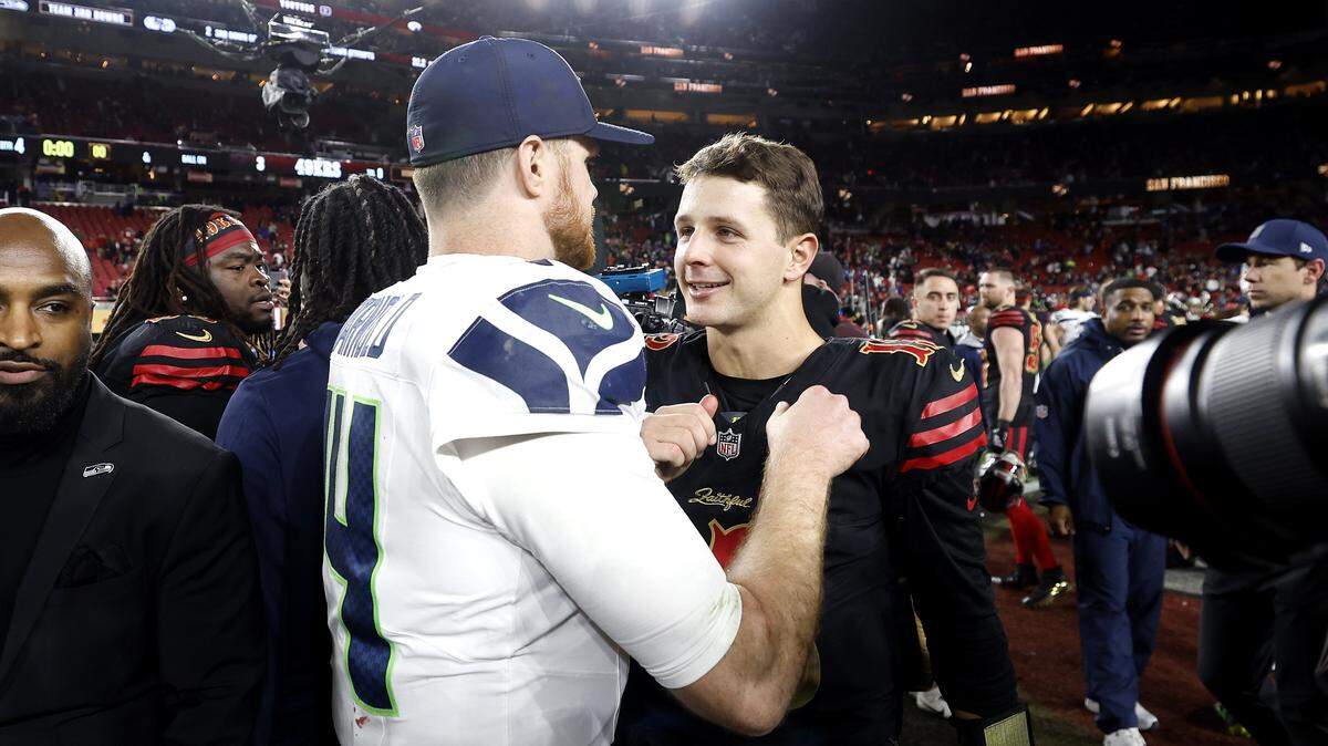 SANTA CLARA, CALIFORNIA - JANUARY 03: Brock Purdy #13 of the San Francisco 49ers shakes hand with Sam Darnold #14 of the Seattle Seahawks following a game at Levi's Stadium on January 03, 2026 in Santa Clara, California. The Seattle Seahawks defeated the San Francisco 49ers 13-3. (Photo by Lachlan Cunningham/Getty Images)