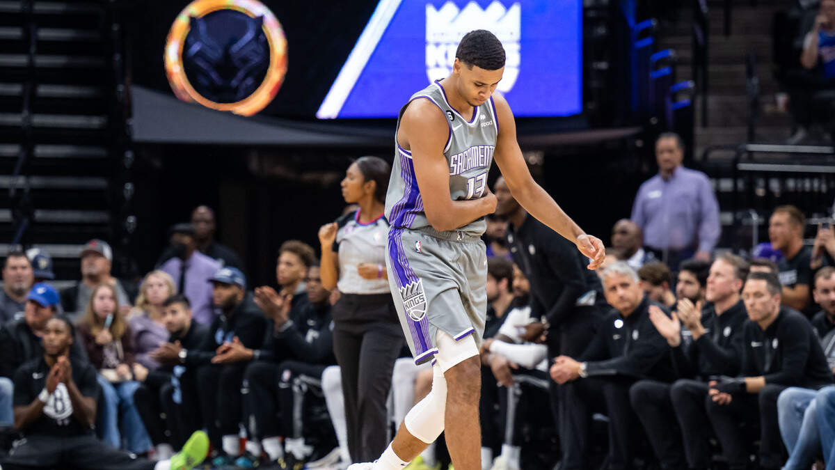 Sacramento Kings forward Keegan Murray (13) grabs his side after a physical play against the Brooklyn Nets in the first half of the NBA basketball game Tuesday, Nov. 15, 2022, at Golden 1 Center in Sacramento.