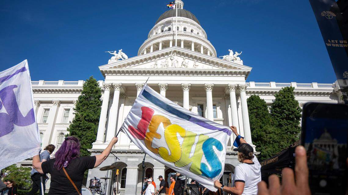 Participants in the “Let Us Worship” rally hold up a Jesus flag before a performance by Christian faith leader and musician Sean Feucht on Saturday, June 8, 2024. Christian nationalism and public prayer calls challenge religious liberty, school prayer debates and the founders’ vision of church-state separation.