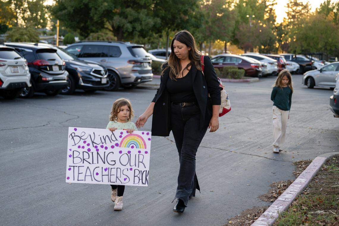 Anastasia Dolotov walks through the parking lot with her children, Josephine and Vivienne, to attend the Sacramento City Unified School District board meeting on Thursday. They attended to show their support for teachers Jeanine Rupert and Mark Henrikson, who were recently removed by district administrators.