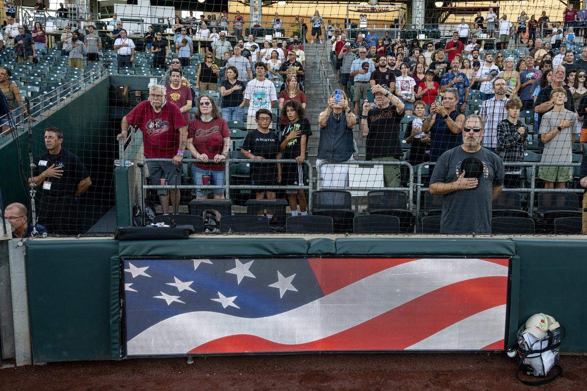 Fans stand during the national anthem before the Sacramento River Cats played the El Paso Chihuahuas on Aug. 20 at Sutter Health Park in West Sacramento.