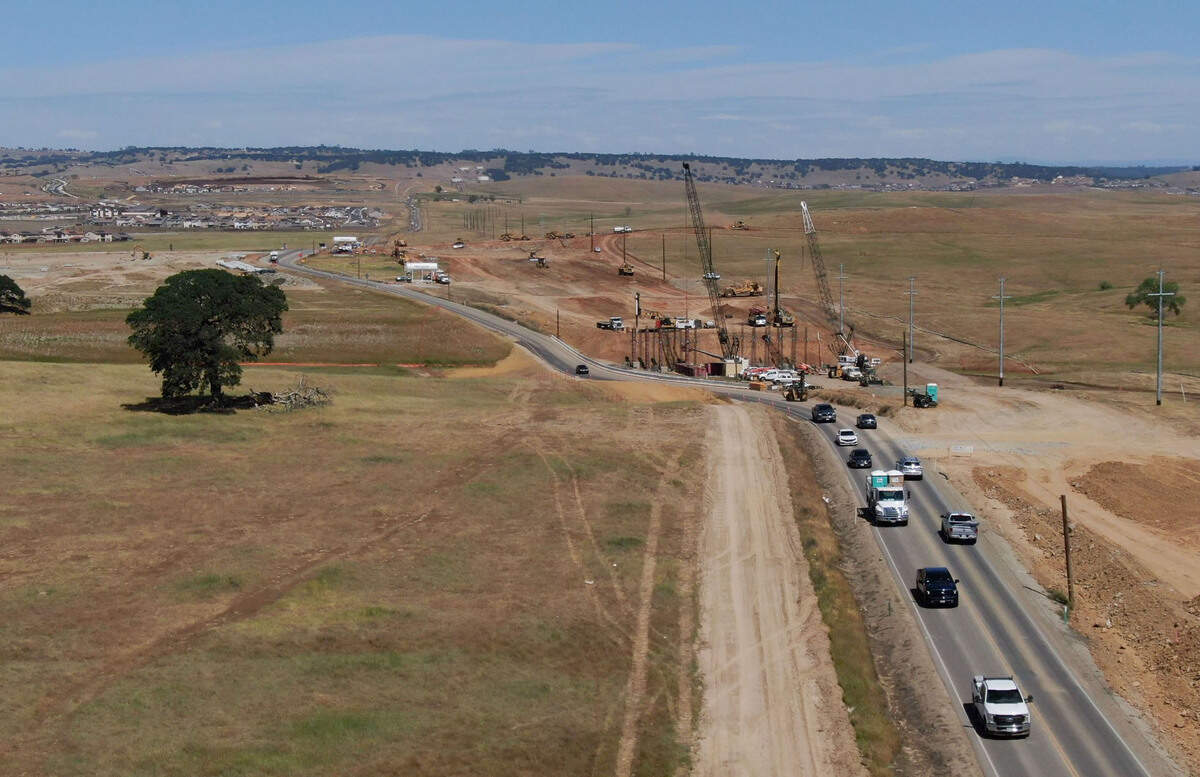 Construction for the planned Sacramento Capital SouthEast Connector, adding lanes to White Rock Road between East Bidwell Street and Prairie City Road, is underway May 6, 2021, as Folsom housing developments at top right reach further south into rolling hills of eastern Sacramento County. Officials expect the new “freeway,” when completed, will relieve traffic on Highway 50 and Highway 99.