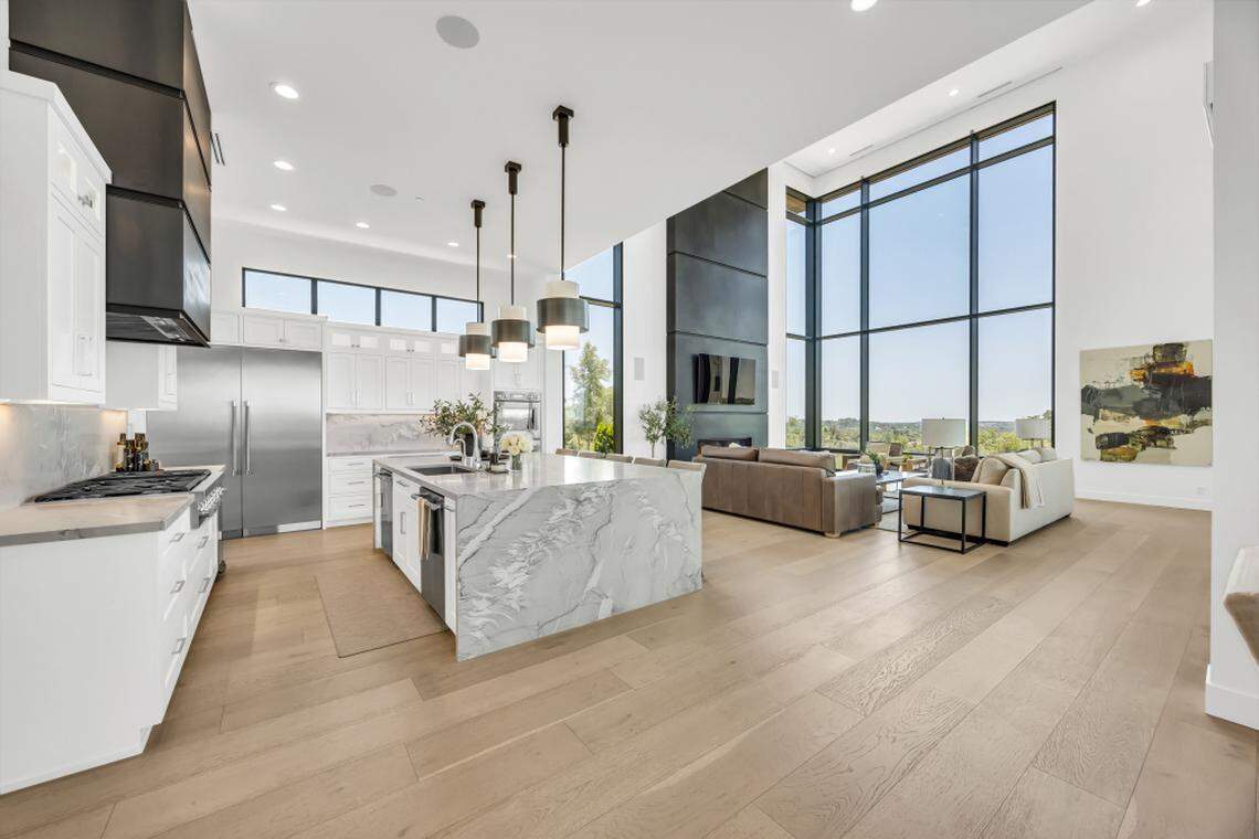 The chef’s kitchen features top-of-the-line appliances, a hidden butler’s pantry and waterfall island.
