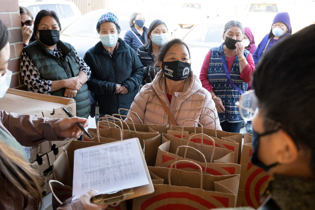 Nai Seng Saelee, center, was one of 78 lu Mien seniors receiving food at the Stockton Boulevard Partnership in South Sacramento on Nov. 20, at the lu Mien Community Services Center's grocery giveaway. 