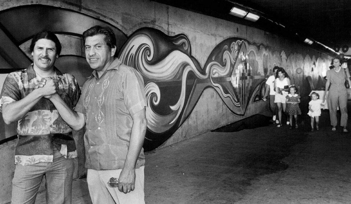 Muralists Juan lshi Orosco, left, and Esteban Villa stand in front of their recently completed mural in Sacramento’s Capitol Plaza tunnel, which runs between Downtown Plaza and Old Sacramento, in August 1984. The acrylic and tile mural was funded by the Sacramento Arts Commission’s Art in Public Places program.