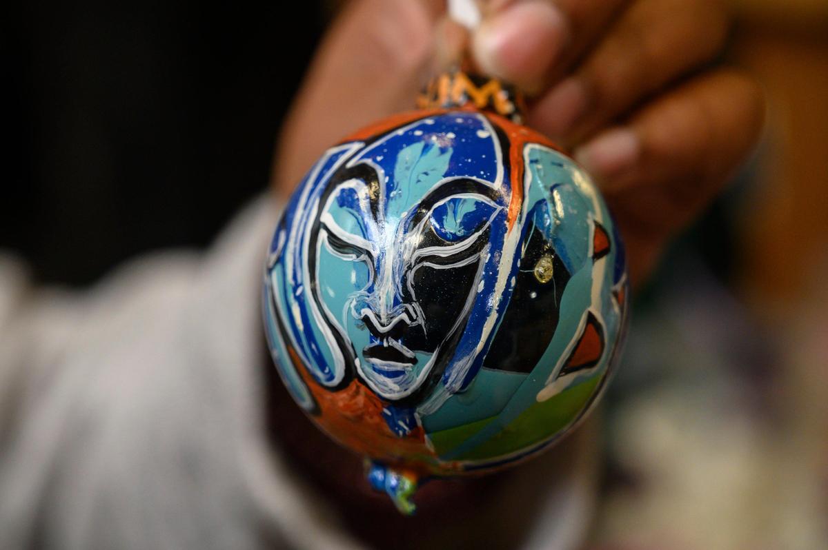 Grammy award winning musician Woodrowe Farguheson Jr., known by the artist name Tsumnu and musician aka M.C. RadioActive, works in his studio in Sacramento painting and creating Christmas ornaments on Thursday, Nov. 14, 2019.