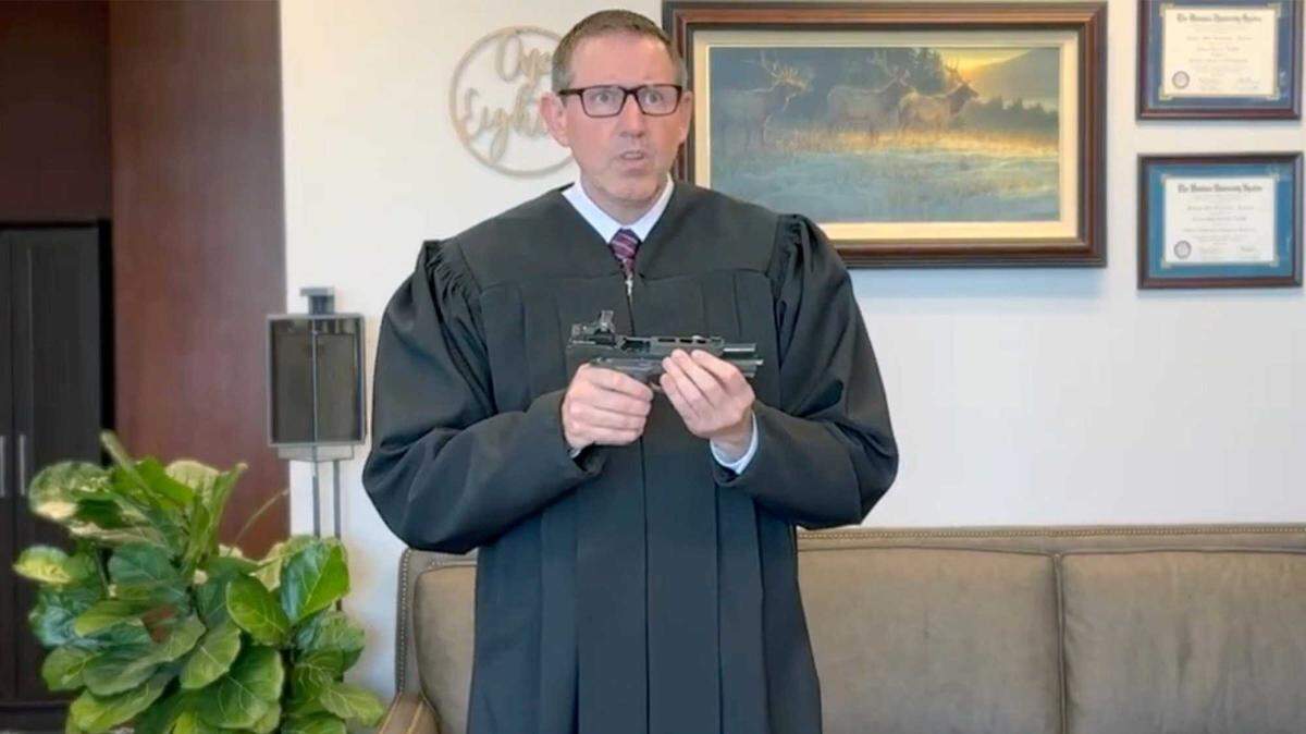In a video, U.S. District Judge Lawrence VanDyke demonstrates with a firearm as he explains his dissent opinion in Duncan v. Bonta, another Second Amendment case last year. On Friday, VanDyke and two other judges ruled California’s law banning open-carry of firearms was unconstitutional.