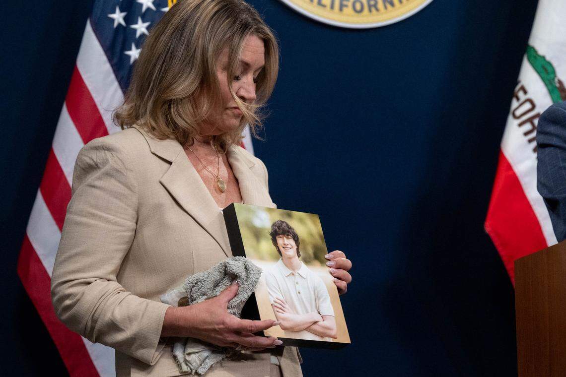 Maria Raine holds a photograph of her son Adam – a California teen who died after forming a parasocial relationship with an AU chatbot – during a news conference with state Sen. Steve Padilla, D-San Diego, and Assemblymember Rebecca Bauer-Kahan, D-Orinda, at the state Capitol swing space on Monday. 