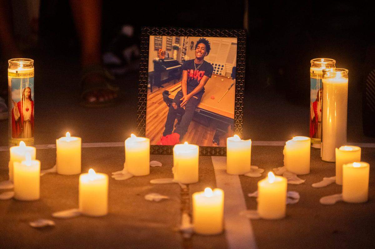 A photo of Colby Tevis is illuminated by candles during a vigil at Burberry Community Park in Sacramento on Monday. Colby was killed and another hospitalized after a shooting early Saturday morning on J Street in midtown.