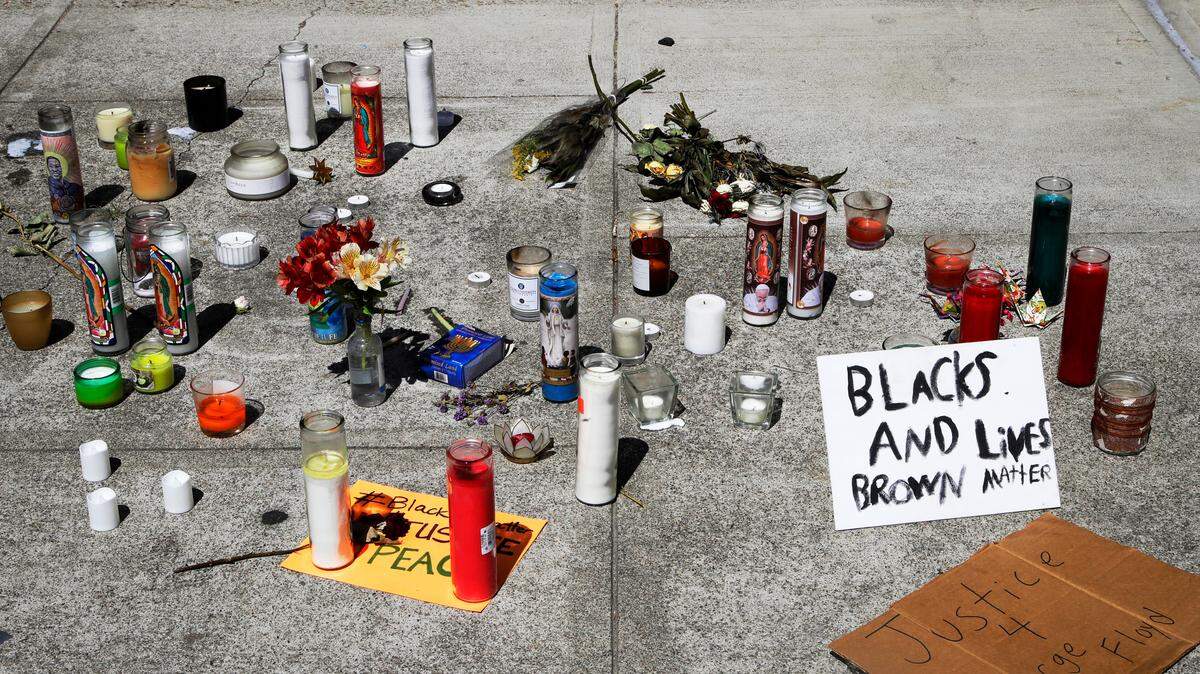 FILE - This June 3, 2020 file photo shows candles and signs at the entrance to closed Vallejo, Calif., City Hall. California Attorney General Xavier Becerra announced Friday, June 5, 2020 his office will review the Vallejo police department to reform its use-of-force policies and improve its anti-bias and community policing after officers there shot and killed a 22-year-old man suspected of stealing amid a night of protests. Becerra said the review of the department was not tied to a specific incident but what the Department of Justice called “several recent high-profile VPD officer-involved shootings.” (AP Photo/Ben Margot, File)