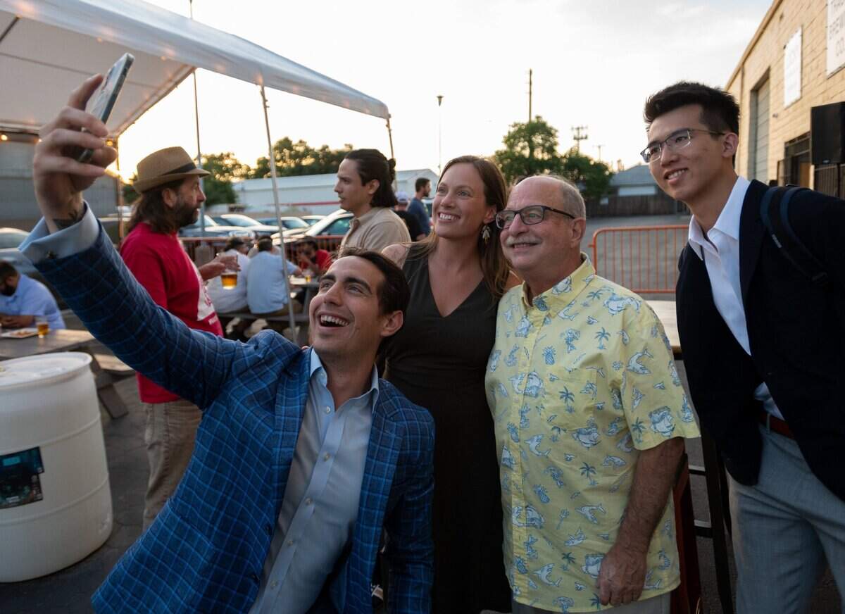 Alex Torres takes a photo with candidate Caity Maple and supporters Larry Tract and Alec Tong during her election watch party at the Track 7 Brewery in Sacramento, Tuesday, June 7, 2022. Caity Maple, 30, is running for the Sacramento City Council representing District 5.