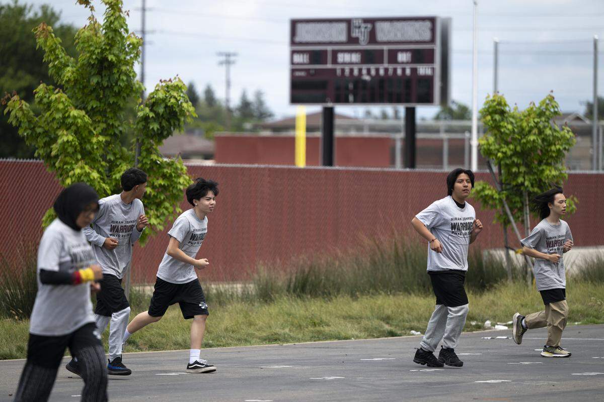 Students wearing T-shirts that read “Warriors” participate in gym class at Hiram Johnson High School in Sacramento on Tuesday.