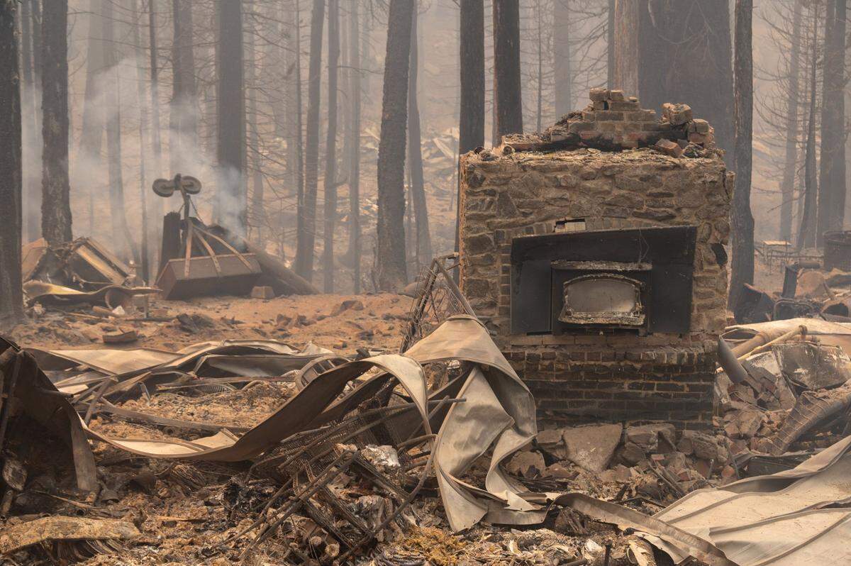 A burned fireplace is all that remains of a home Monday after the Caldor Fire passed through the area along Highway 50 near Sierra-at-Tahoe ski resort in the Eldorado National Forest.
