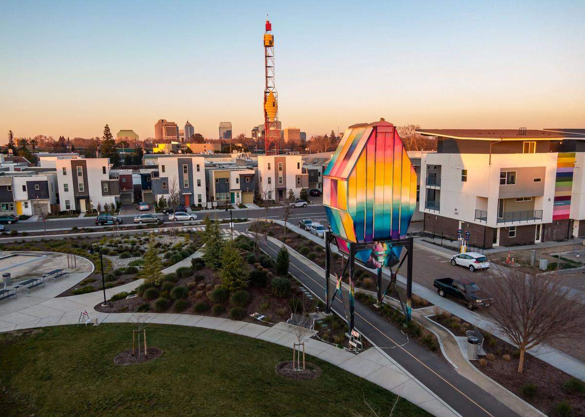 An original piece of mill equipment, painted by artist Jose Di Gregorio, is a focal point at the edge of Olympians Park in The Mill at Broadway development in Sacramento’s Upper Land Park neighborhood on Jan. 27, 2022. The former industrial site has been redeveloped into a relatively affordable destination for new homeowners.