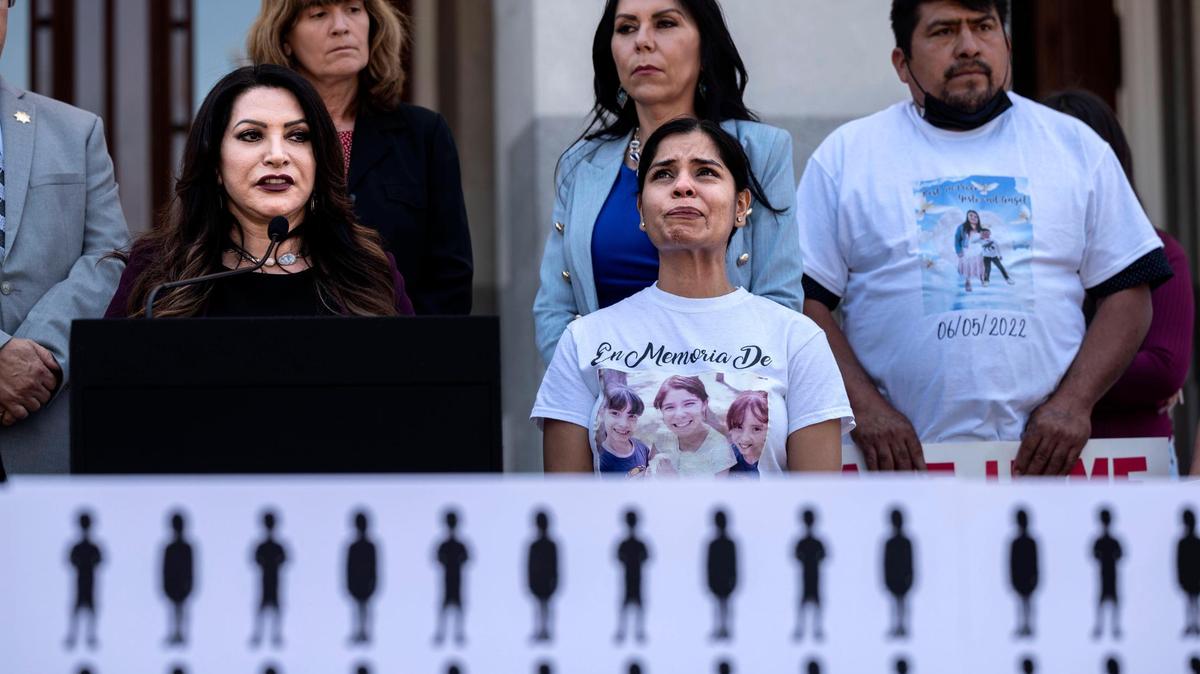 Ileana Gutierrez, wearing a shirt with photographs of her three daughters killed in Arden Arcade by father David Mora in February, holds back tears as she appears at a press conference with state Sen. Susan Rubio, D-Baldwin Park, at the state Capitol on Monday. Rubio is sponsoring a bill known as Piqui’s Law, which would force family court judges to learn more about domestic violence, with the aim of applying that to contested custody cases.