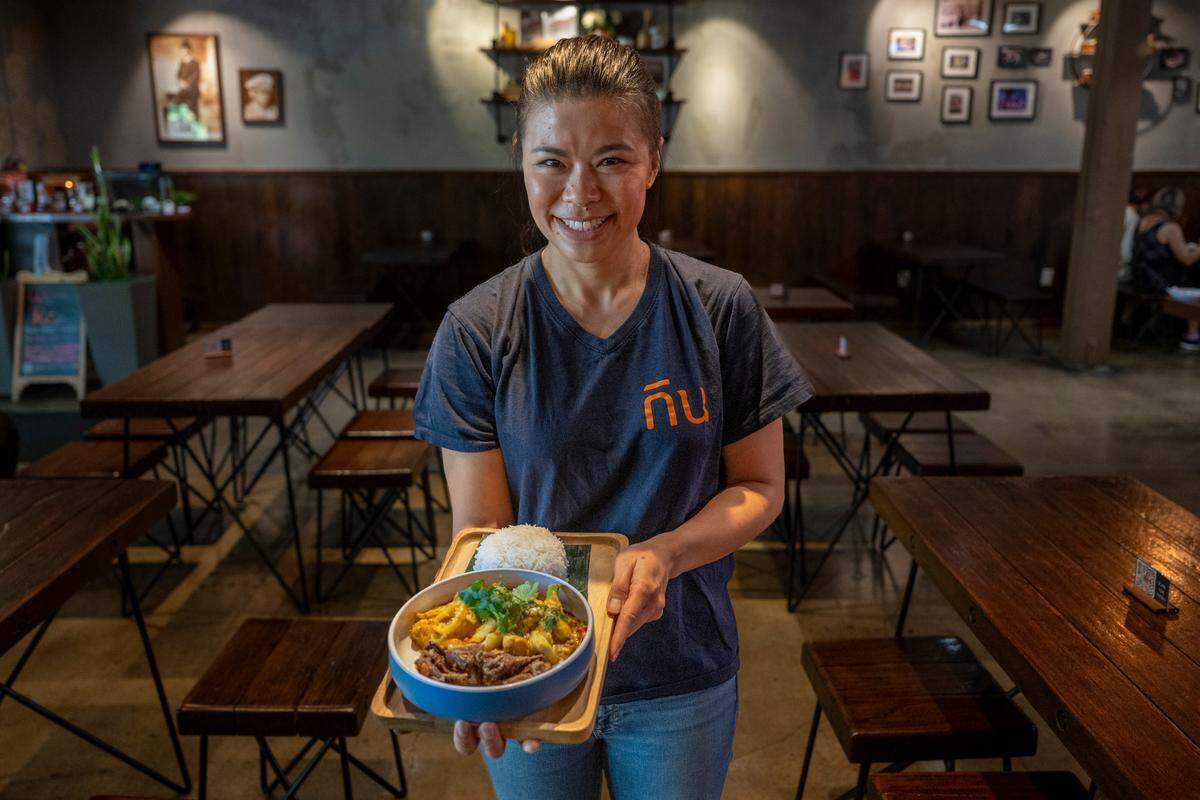 Napang Kongsitthanakorn holds a plate of Crab Curry at Kin Thai Street Eatery in midtown Sacramento, the city’s first Thai restaurant named to the Michelin California Guide. The family-run spot earned its 2025 recommendation for dishes like this soft shell crab curry, a former special now permanent on the menu.