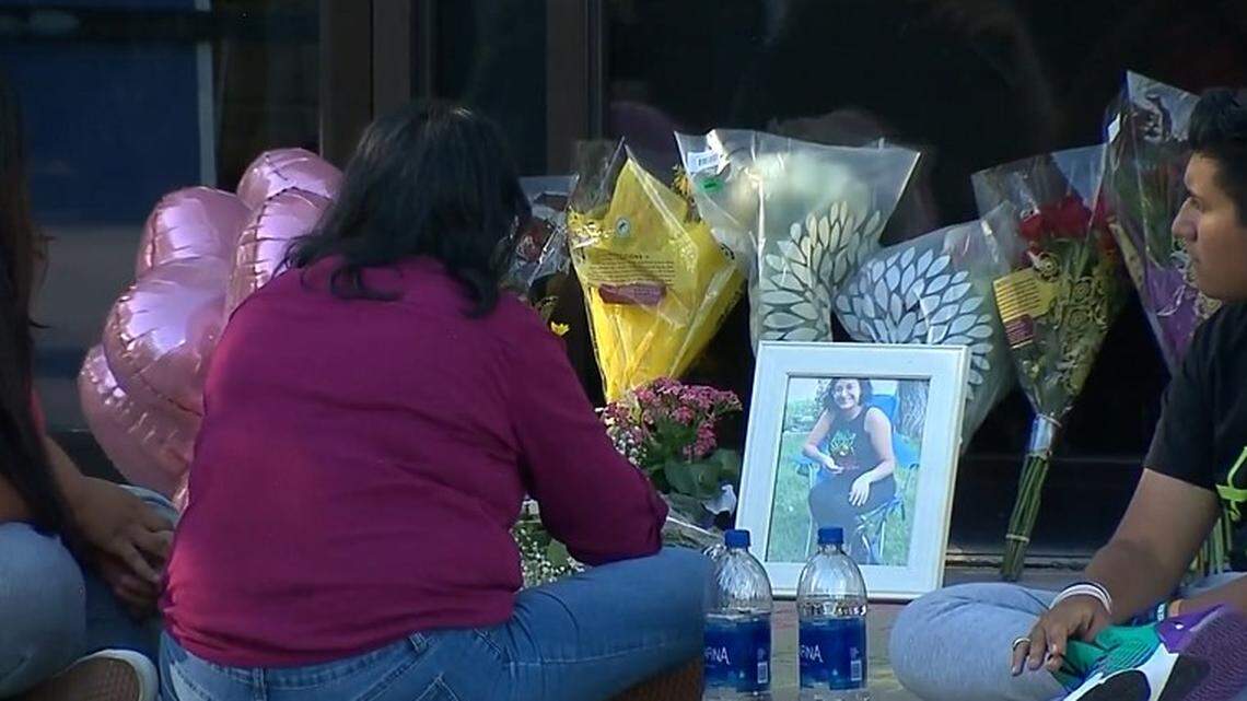 Mourners grieve at a memorial for Angie Vega, 22, who was found sexually assaulted and killed in her vehicle after police discovered her missing from a Greeley, Colorado, store.
