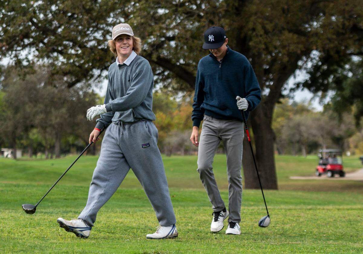 Sacramento residents Matt Cherovsky and Nick Wackford walk to their golf balls at Haggin Oaks Golf Complex in October.