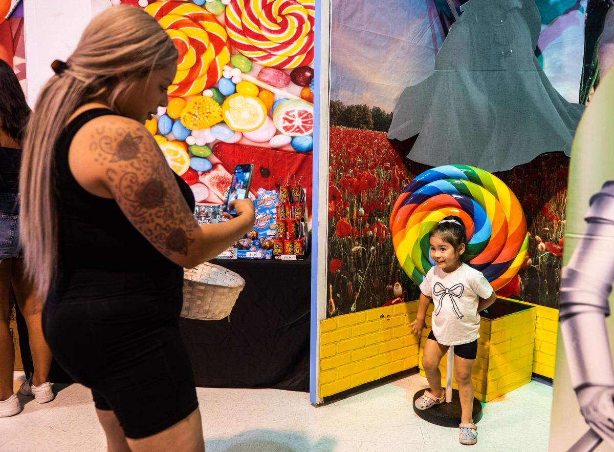 Alyssa Rosales takes a picture of her daughter Gianna Rodriguez, 2, at the California State Fair’s Candy Maze Selfie Experience on Friday.