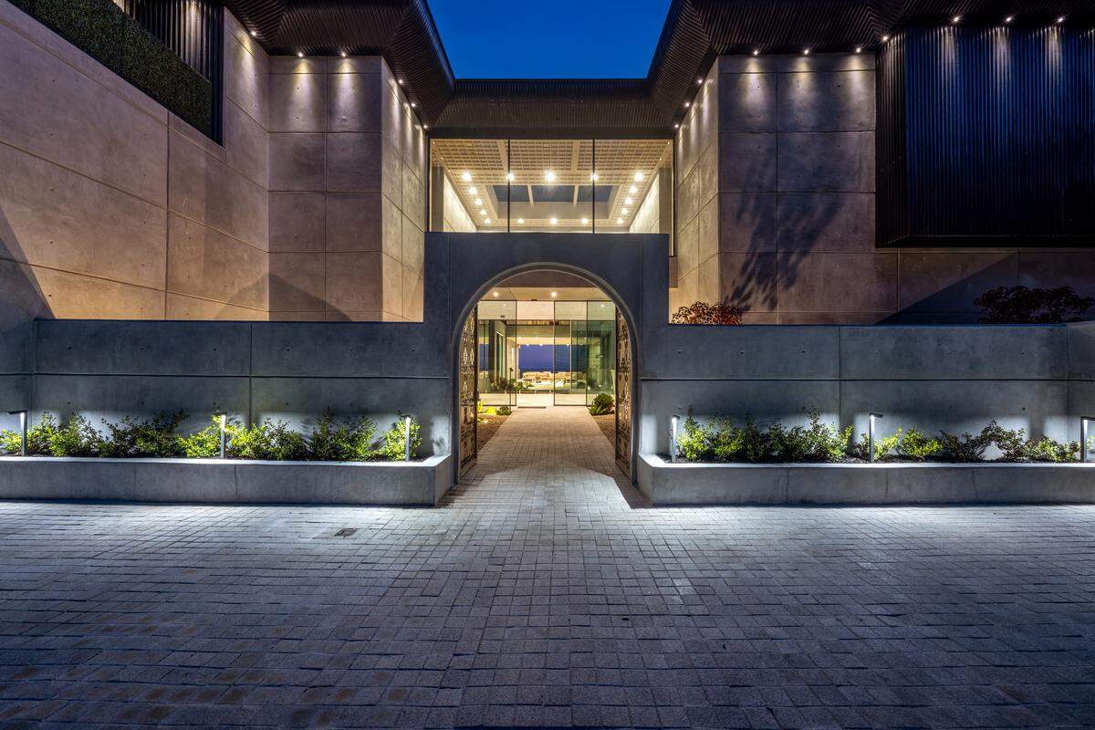 Simka Malibu rises from a bluff above the Pacific, its 30,000-square-foot concrete-and-glass design intentionally built to endure fire, earthquakes, and coastal erosion; the estate is listed at $35 million and offers 10 bedrooms and 20 bathrooms.