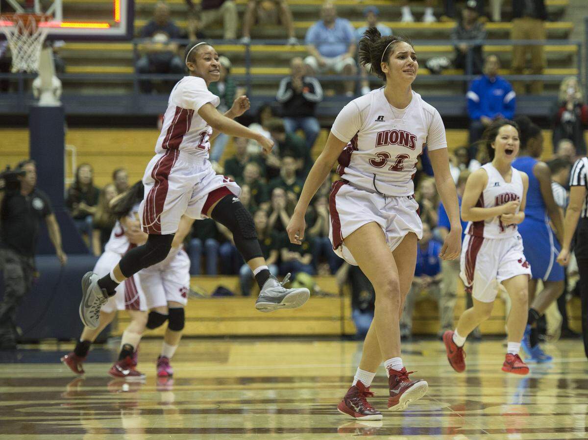 McClatchy Lions' Gigi Garcia (32), Alex Washington (25), Kelsey Wong (3) and Sara Shimizu (14) celebrate following the 65-61 double overtime victory on March 27, 2015 in the CIF State Division I championship game against Serra at Haas Pavilion in Berkeley.