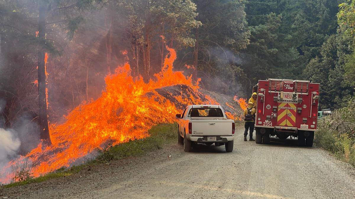 Fire crews work to extinguish the Hill Fire in Humboldt County. The wildfire broke out July 16 and has burned more than 6,600 acres as of Wednesday afternoon, with crews having established 10% containment.