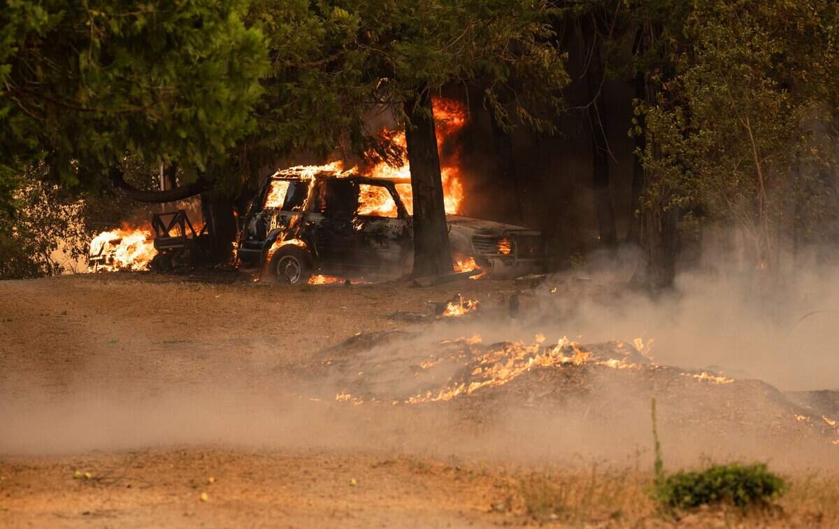 The River Fire burns a car off Mount Olive Road on Wednesday, Aug. 4, 2021, in Nevada County.