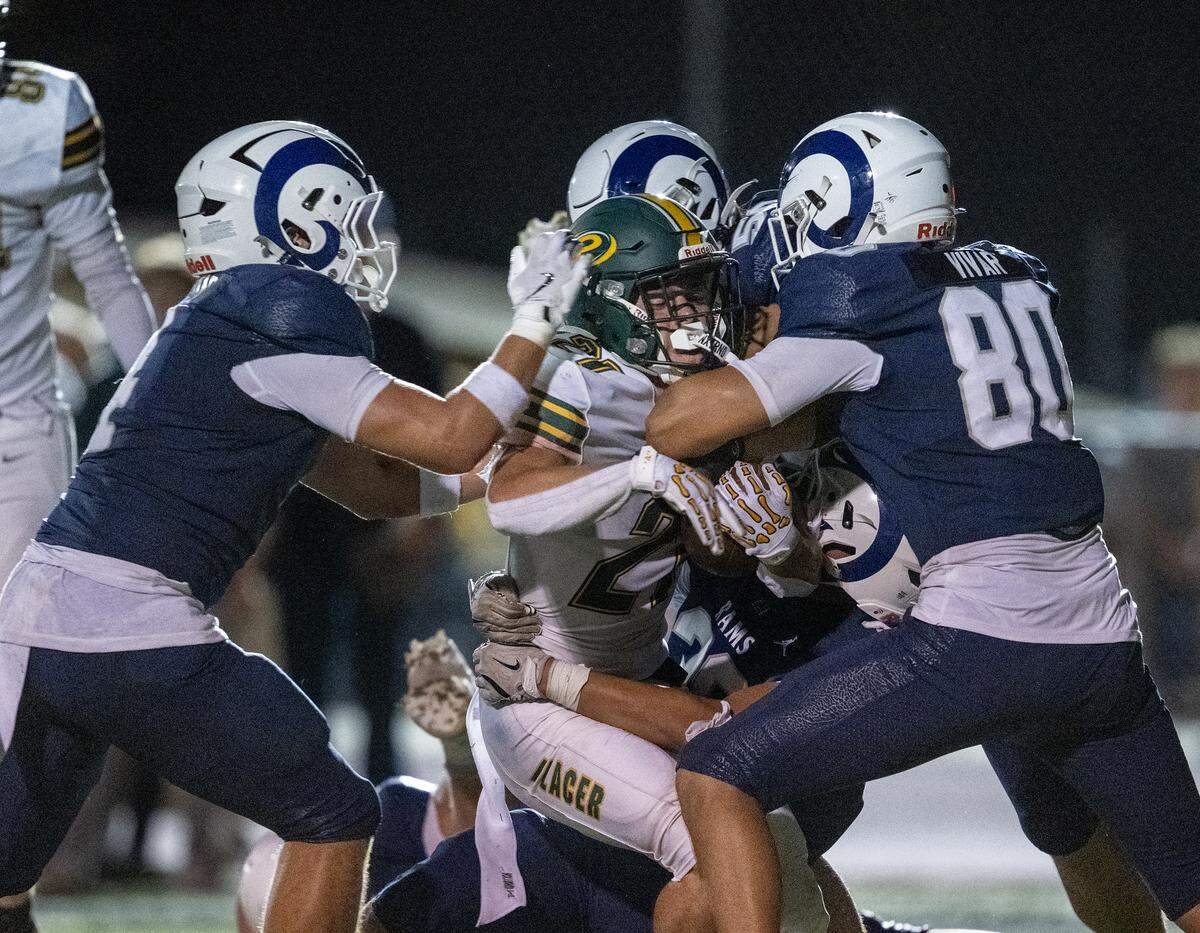The Placer Hillman' Danny Sanchez-Harlow (21) is brought down by the The Casa Roble Rams defense in the first half on Friday in Orangevale.