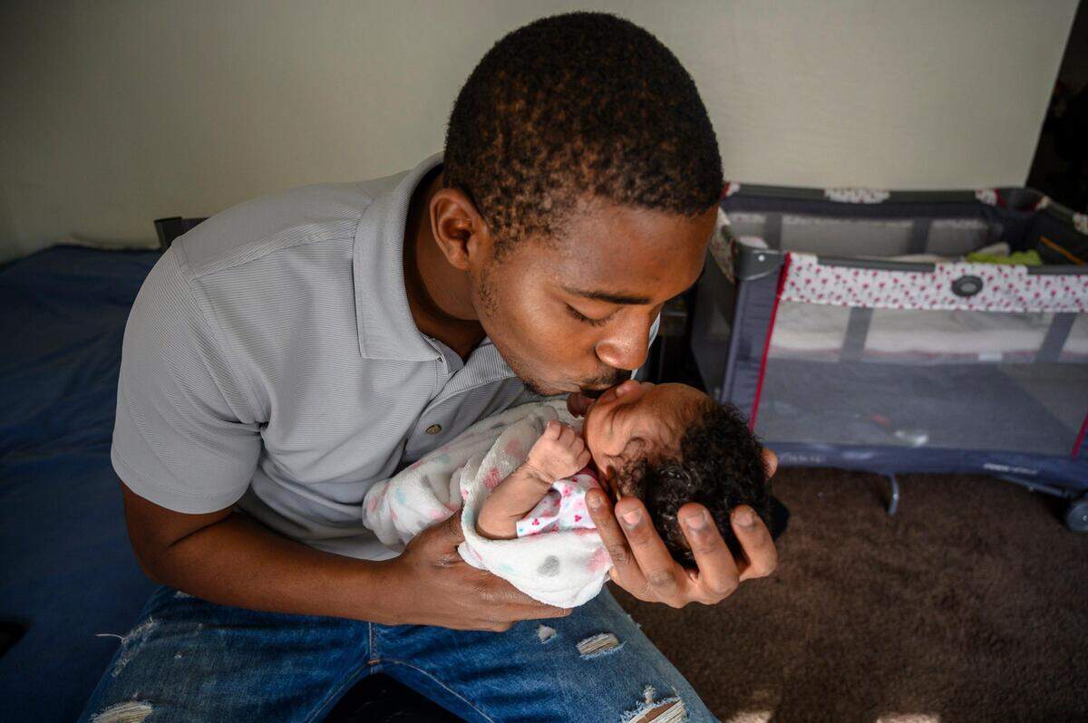 9. Formerly homeless Marcelous Bell, 21, kisses his daughter Amelia Bell, 13-days-old, in his apartment on Wednesday, Jan. 23, 2019 in Sacramento. He says he finally feels safe after living on the streets for almost three years.