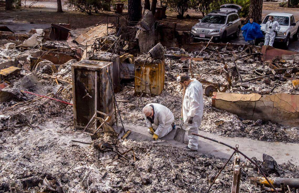 In hazmat suits provided by town officials, residents of Paradise were first able to return to their properties on Dec. 5, 2018 – almost a month after the destructive Camp Fire. Paradise resident Lou Donnelly, left, works on the rubble of his home with his brother-in-law Donald Weeks.