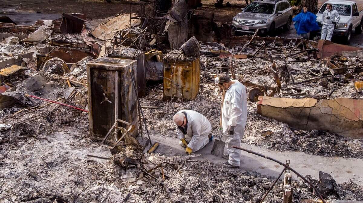 Lou Donnelly, left, of Paradise works on the rubble of his home after the Camp Fire with his brother-in-law Donald Weeks of San Diego on Wednesday, Dec. 5, 2018. Donnelly is living with his son until his home is rebuilt.