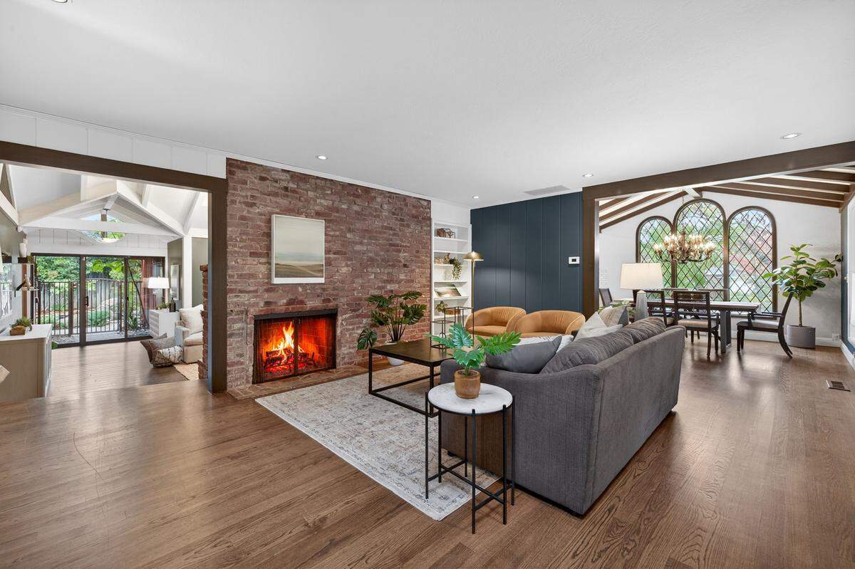 Vaulted ceilings and abundant natural light create an artful living space in a desirable neighborhood.