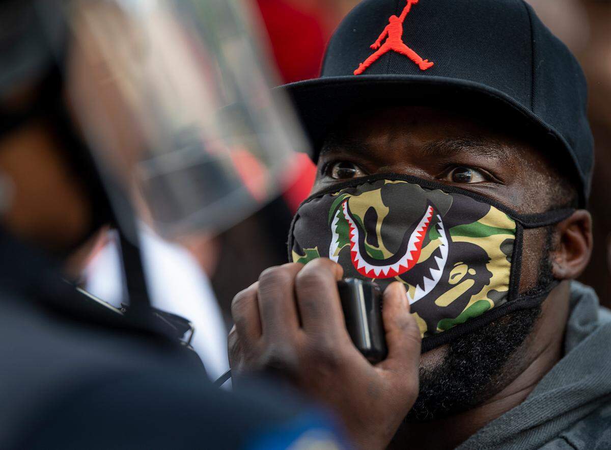 Demonstrators face-off with Sacramento Police officers during a protest organized by Black Lives Matter Sacramento over the death of George Floyd on Friday, May 29, 2020 in Sacramento during the coronavirus pandemic. George Floyd died in Minneapolis Monday after being detained by police.
